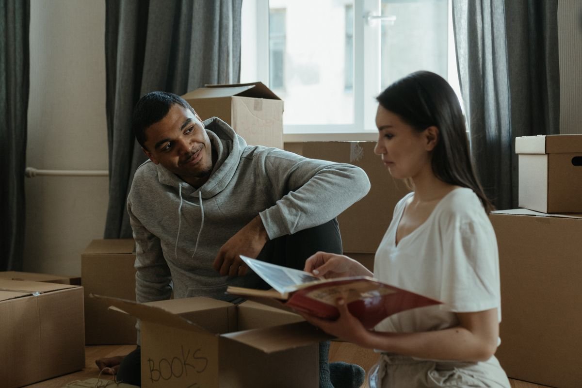 Couple unpacking cardboard boxes in a bright new home