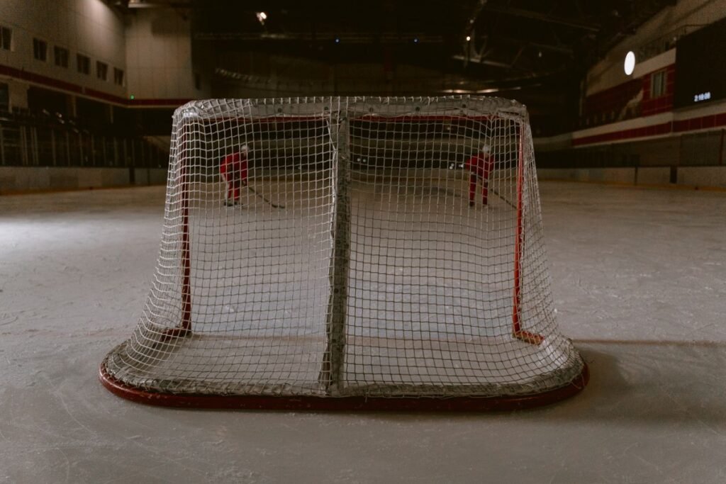 Hockey Jerseys for Fans Choosing Between Captains, Stars and Rising Rookies Empty hockey net on the ice in a dark arena
