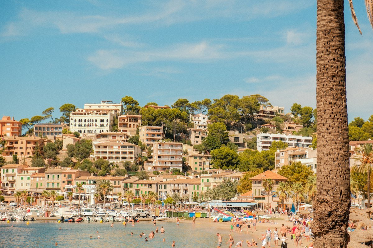 Majorcan hillside town with terracotta roofs above the sea
