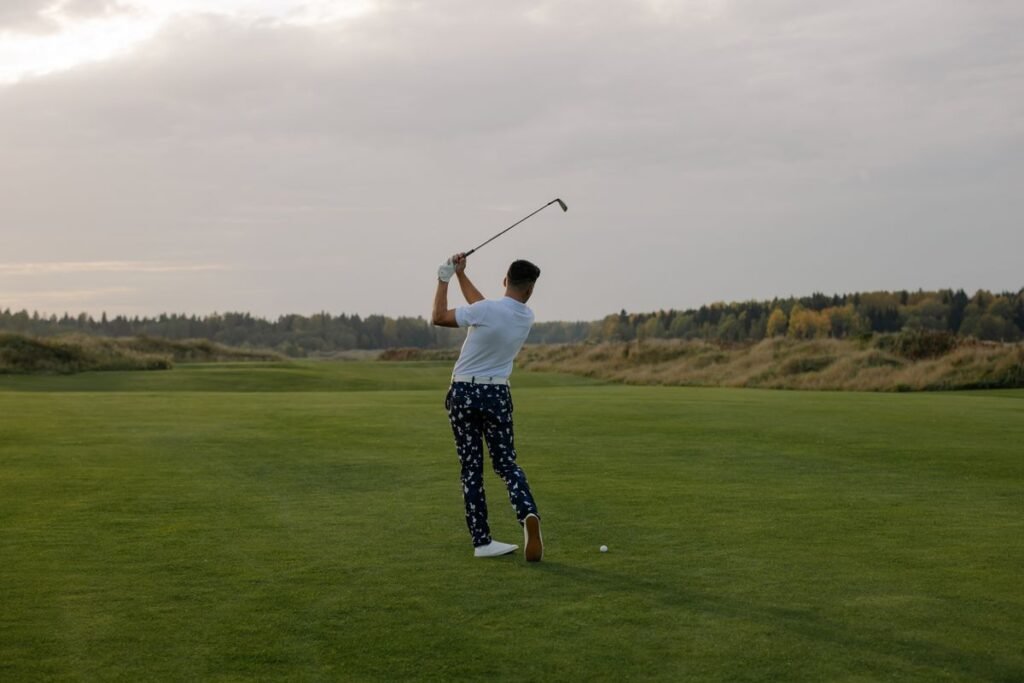 Golfer finishing a swing on the fairway
