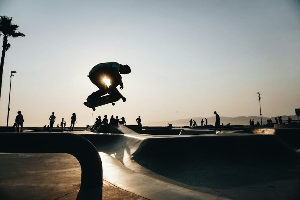 Skateboarder silhouetted mid-air at a skatepark