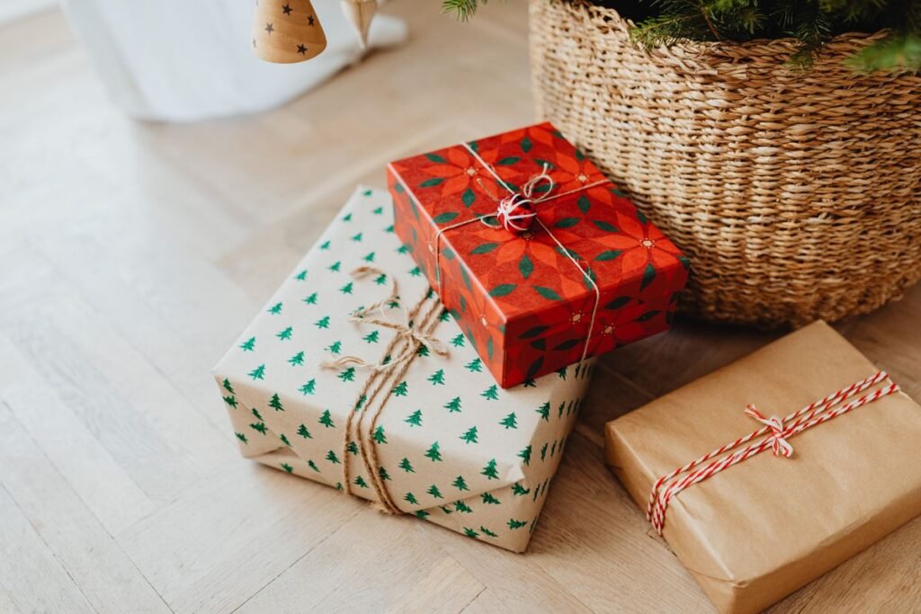 Wrapped holiday gifts on the floor beside a Christmas tree