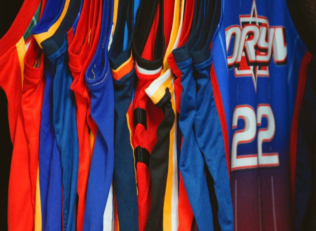 Rack of retro basketball jerseys in classic team colors