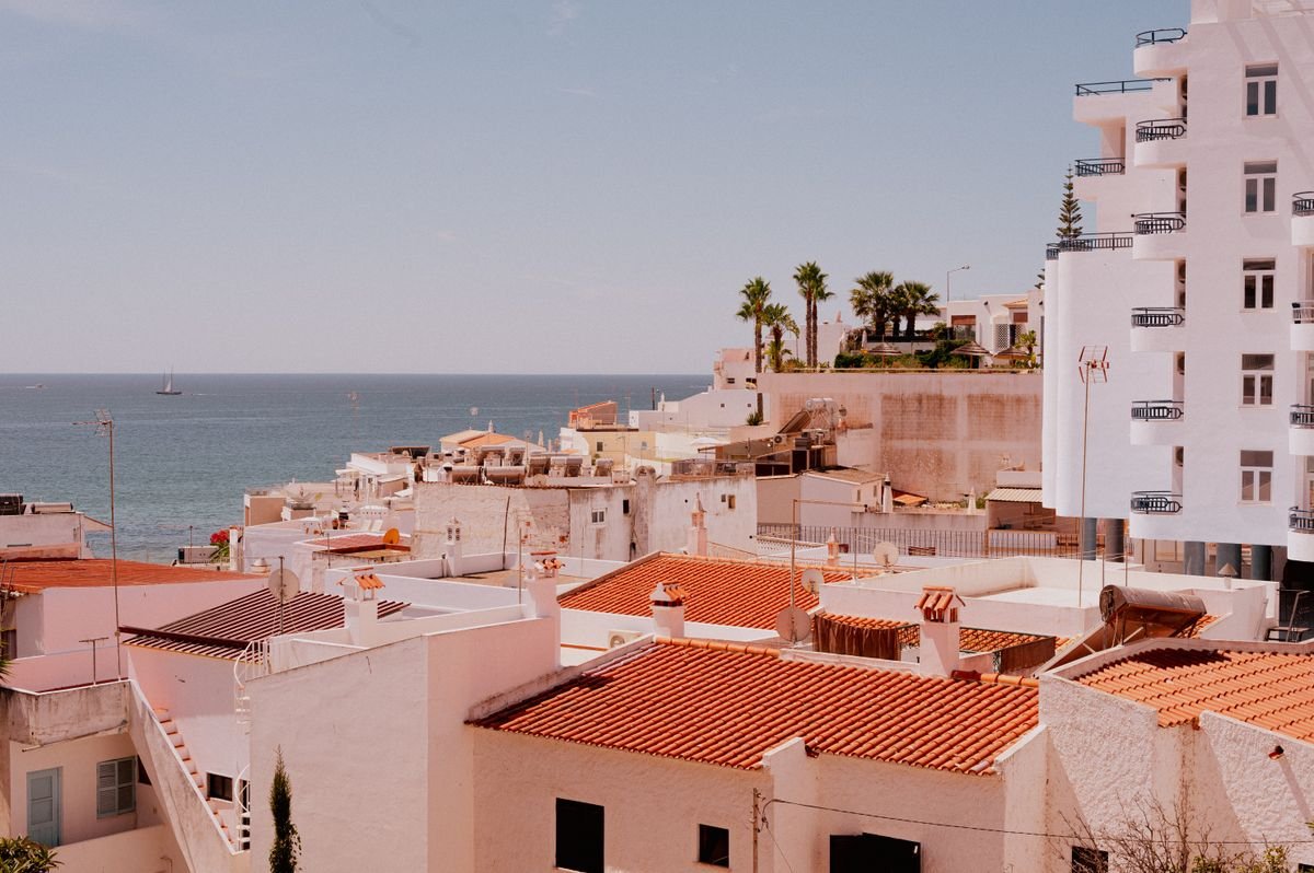 Whitewashed Algarve town rooftops looking out to the sea